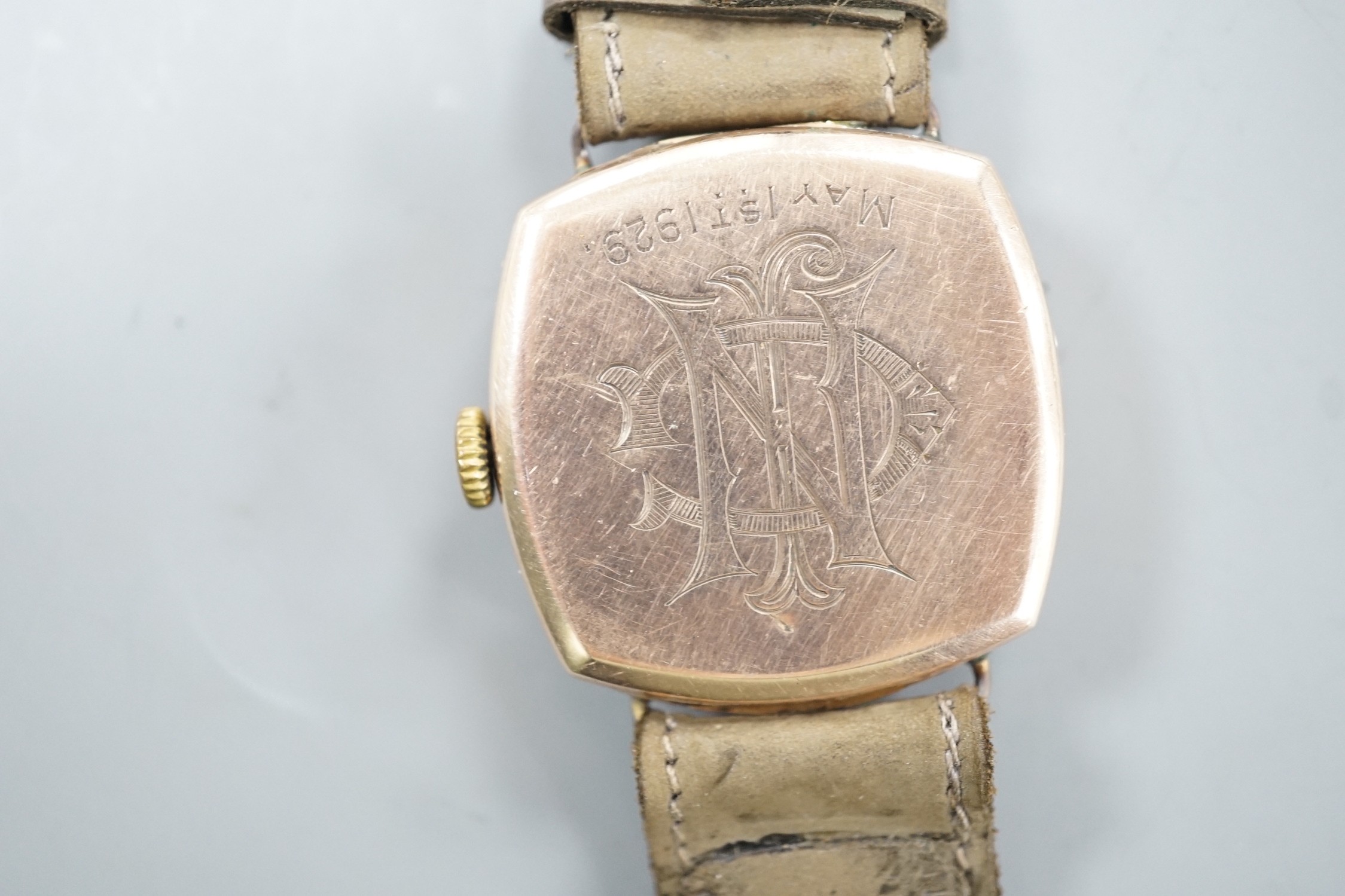 A gentleman's 1920's 9ct gold Rolex manual wind wrist watch, on associated strap, with case back inscription.